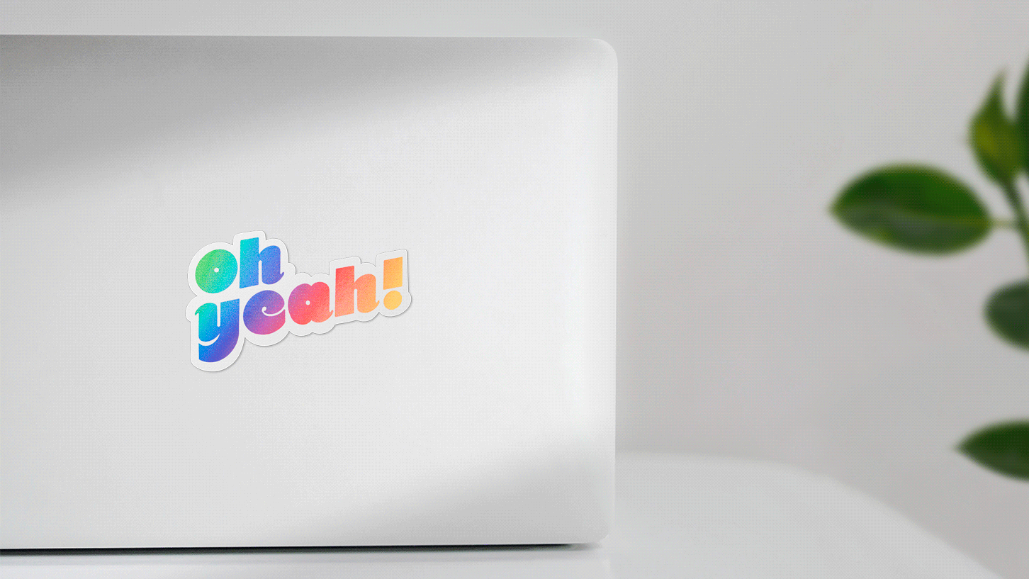 Stickers of the hand lettering logo "oh yeah" on a mac computer. By Meg Chikhani