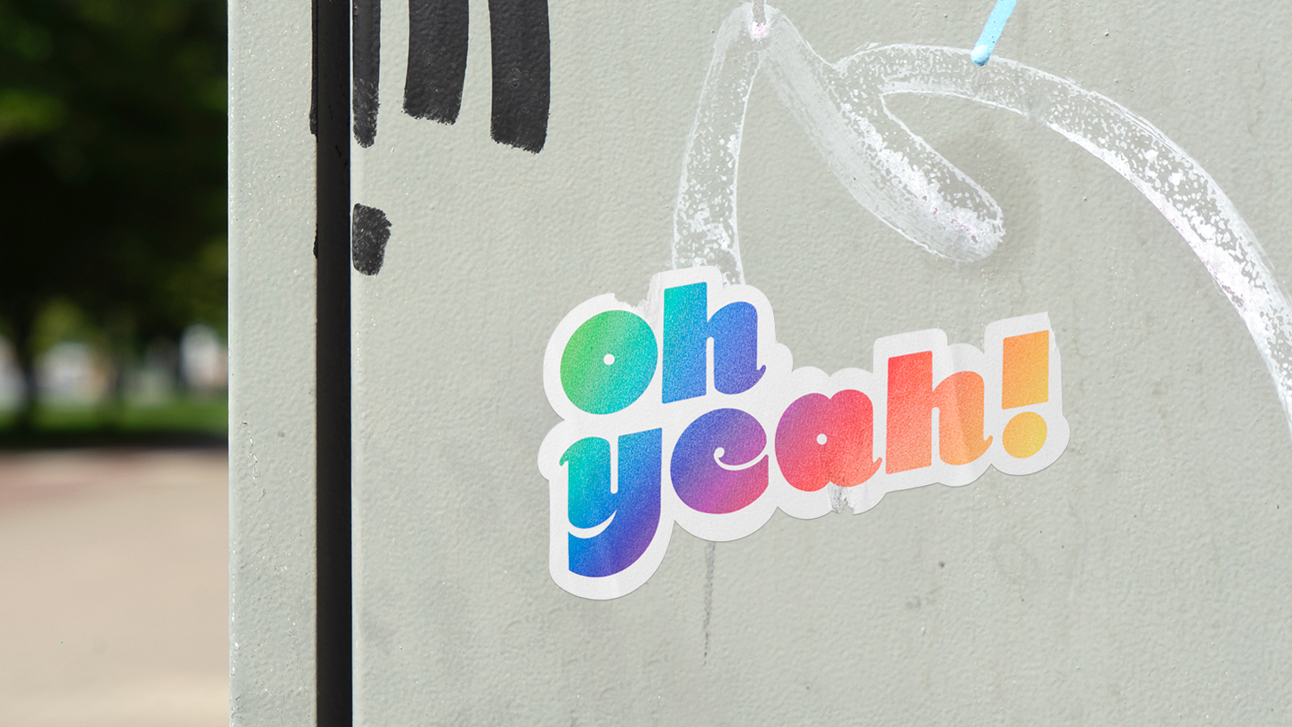 Sticker of the hand lettering logo "oh yeah" in the city. Graphic design by Meg Chikhani